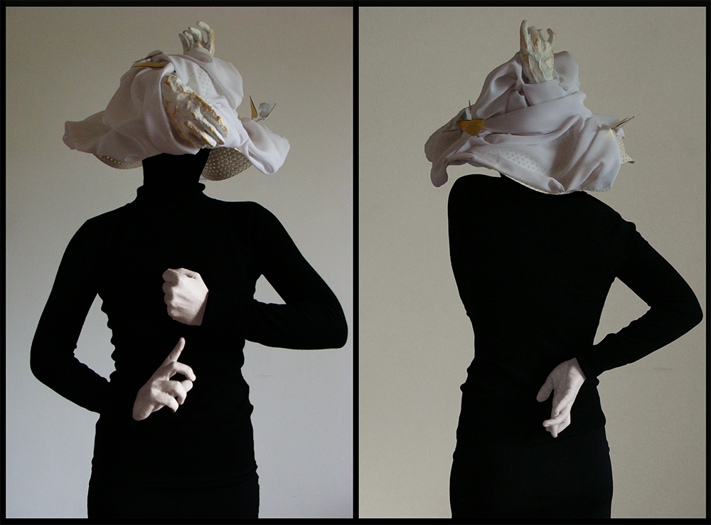 theatrical hat made of white silk and hand prosthetics